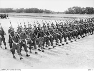 TOROKINA, BOUGAINVILLE. 1945-10-22. A CEREMONIAL PARADE AND MARCH PAST BY 29 INFANTRY BRIGADE WAS HELD FOR MAJOR-GENERAL BRIDGEFORD, GENERAL OFFICER COMMANDING 3 DIVISION, AT TOROKINA AIRFIELD. ..
