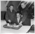 Sgt. Isamu Sanemitsu, with several fellow-patients, partakes of his mess in the ward at Moore General Hospital where he is