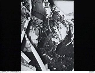 ESPIRITU SANTO, NEW HEBRIDES. 1943-07-23. VIEW OF TORPEDO DAMAGE TO THE CRUISER HMAS HOBART (I) INSIDE THE WARDROOM LOOKING AFT FROM ABOUT FRAME 173, NINE FEET INBOARD. NOTE THE CABLE JAMMED UNDER ..