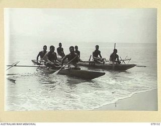 TSIMBA AREA, BOUGAINVILLE ISLAND. 1945-02-19. NEW GUINEA ADMINISTRATIVE UNIT (NGAU) NATIVES AND MEMBERS OF THE NEW GUINEA CONSTABULARY IN TWO NATIVE CANOES MADE EXPECIALLY FOR THE TASK OF SAILING ..