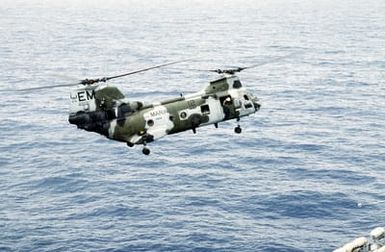 A Marine Medium Helicopter Squadon 261 (HMM-261) CH-46E Sea Knight helicopter comes in for a landing aboard the amphibious assault ship USS SAIPAN (LHA-2) during a rehearsal for Operation Sharp Edge. The SAIPAN is on station off the coast of Liberia