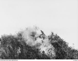NEW GUINEA. 22 MARCH 1944. A BOMB EXPLODING ON THE PIMPLE AT SHAGGY RIDGE. AN ACTION PICTURE FROM THE DEPARTMENT OF INFORMATION FILM "JUNGLE PATROL"