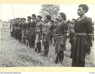 1943-02-04. NEW GUINEA. NATIVES WHO PLAYED A GREAT PART IN THE ALLIED SUCCESS IN NEW GUINEA ARE ADDRESSED BY GENERAL VASEY. NATIVE POLICE FORM A GUARD OF HONOUR AS NATIVE CARRIERS ARE PRESENTED ..