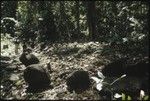 Men in forest with shrine