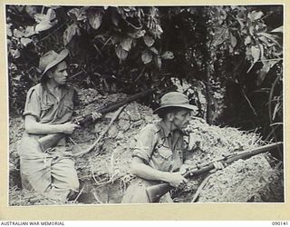 DAGUA, NEW GUINEA. 1945-03-27. PTE C. JANSEN (1), AND LT-CPL E. DUNCAN (2), MEMBERS OF 2/2 INFANTRY BATTALION, IN A WEAPON PIT AT A COMPANY HQ, WHILE ATTACK CONTINUES