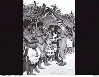 KOIL ISLAND, NEW GUINEA, 1945-10-31. A VISIT TO KOIL ISLAND WAS ARRANGED BY THE RED CROSS FOR THE PURPOSE OF MEDICAL INSPECTION OF THE NATIVE INHABITANTS. THE VISITING PARTY CONSISTED OF AN ..