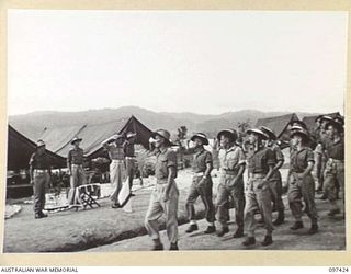 WEWAK POINT, NEW GUINEA. 1945-10-02. AFTER THE PRESENTATION OF THE MILITARY MEDAL RIBBONS TO SERGEANT E. HAYLETT AND CORPORAL G.A. LAMBERT, MEMBERS OF 12 PLATOON, C COMPANY, 2/3 MACHINE-GUN ..