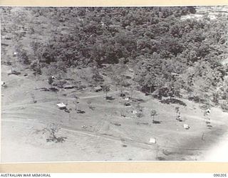 GOODENOUGH ISLAND, NEW GUINEA. 1942-10. TENTS AND WHEEL MARKS WITH NEITHER MEN OR VEHICLES WERE PART OF THE BLUFF AND DECEPTION PRACTICED BY A SMALL GROUP OF AUSTRALIANS WHO SEIZED THE ISLAND, AND ..