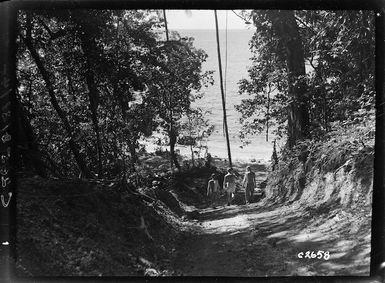 Soldiers walking down a path to a beach at Soanotalu, on Mono Island, Solomon Islands, during World War 2