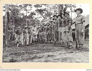 TOL PLANTATION, WIDE BAY, NEW BRITAIN. 1945-07-02. HIS ROYAL HIGHNESS, THE DUKE OF GLOUCESTER, GOVERNOR-GENERAL OF AUSTRALIA (4), SPEAKING WITH TROOPS OF 11 INFANTRY BATTALION WHO ARE LINING THE ..