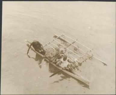 Two women in laden outrigger canoe, Rabaul, New Guinea, ca. 1930 / Sarah Chinnery