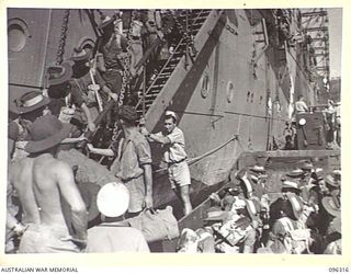 SIMPSON HARBOUR, RABAUL, NEW BRITAIN. 1945-09-10. MEMBERS OF 29/46 INFANTRY BATTALION, MOVING DOWN THE GANGWAY TO GO ASHORE. FOUR LANDING BARGES TOOK THE FIRST WAVE OF TROOPS ASHORE. TROOPS OF 4 ..