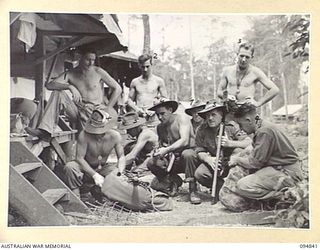 JACQUINOT BAY, NEW BRITAIN, 1945-08-08. PERSONNEL OF 41 LANDING CRAFT COMPANY PACKING UP GEAR BEFORE LEAVING FOR BORNEO. IDENTIFIED PERSONNEL ARE:- CORPORAL MCCINTOSH (1); PRIVATE HOCKING (2); ..