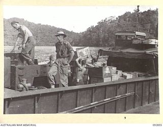NANTAMBU, NEW BRITAIN. 1945-06. LIEUTENANT E.A. WITHINGTON, TRANSPORT OFFICER, 37/52 INFANTRY BATTALION (3), SUPERVISES THE LOADING OF STORES FOR FORWARD TROOPS. IDENTIFIED PERSONNEL ARE:- PRIVATE ..