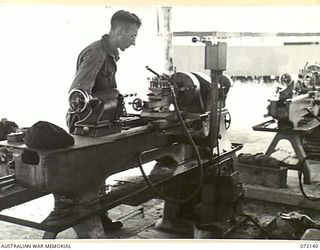 PORT MORESBY, NEW GUINEA. 1944-04-10. VX79778 CRAFTSMAN A.F. HILLIS TURNING BUSHES ON A LATHE AT THE 11TH ADVANCED WORKSHOP, AUSTRALIAN ELECTRICAL AND MECHANICAL ENGINEERS