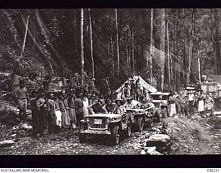 REINHOLD HIGHWAY, NEW GUINEA. 1943-08-23. CONVOY OF HEADQUARTERS ROYAL AUSTRALIAN ENGINEERS, 11TH AUSTRALIAN DIVISION WAS THE FIRST TO TRAVERSE THE NEWLY COMPLETED 68 MILE HIGHWAY BETWEEN BULLDOG ..