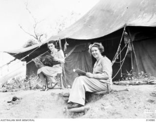 1943-06-10. NEW GUINEA. AT AN AUSTRALIAN GENERAL HOSPITAL IN NEW GUINEA. SISTER E. FOLDER, WYNYARD, TAS. AND SISTER E. BAXTER OF PIPERS RIVER, TAS. SIT OUTSIDE THEIR TENT. (NEGATIVE BY N. BROWN)