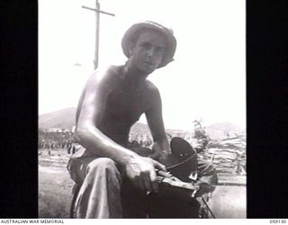 HANABADA, NEW GUINEA. 1943-10-23. A BARE-CHESTED SX9587 CORPORAL N. A. PHILLPOTTS, ELECTRIC WELDER OF THE 14TH AUSTRALIAN FIELD COMPANY, ROYAL AUSTRALIAN ENGINEERS (RAE). HIS JOB IS WELDING THE ..