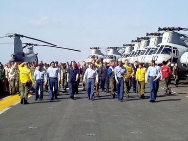 US Navy sailors and US Marines aboard the amphibious assault ship USS GUAM (LPH 9) walk down the flight deck searching for Foreign Object Debris (FOD). GUAM is deployed to the Persian Gulf in support of Operation SOUTHERN WATCH, 15 February 1998