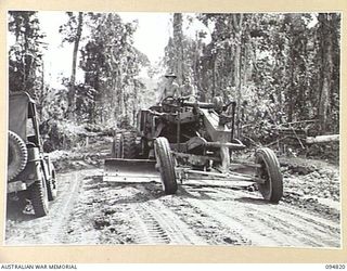 BULUS RIVER AREA, NEW BRITAIN, 1945-08-02. AN "AUTOPATROL" POWER GRADER OPERATED BY 55 FIELD PARK COMPANY, ROYAL AUSTRALIAN ENGINEERS, WORKING ON THE ROAD BETWEEN THE BULUS AND MOONDEI RIVERS