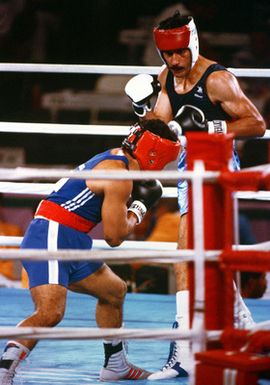 Army SPECIALIST Fourth Class Aristedes Gonzalez, in dark blue, representing Puerto Rico, boxes Paulo Tuvale of Western Samoa during the 1984 Summer Olympics