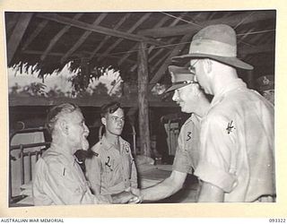 LAE AREA, NEW GUINEA, 1945-06-28. HIS ROYAL HIGHNESS, THE DUKE OF GLOUCESTER, GOVERNOR-GENERAL OF AUSTRALIA (3) BEING INTRODUCED TO FATHER SEILLER (1) WHO CAME FROM ALSACE LORRAINE TO BOUGAINVILLE ..