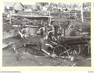 SORAKEN, BOUGAINVILLE. 1945-06-02. NO. 1 GUN OF 2 MOUNTAIN BATTERY WITH ITS CREW IN POSITION. NOTE THE FLOODED GUN PIT