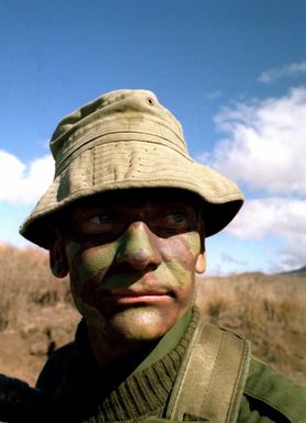 Major Peter Maher, Commander, Company C, Royal Australian Regiment and commander of the opposing forces against the 35th Infantry, 25th Infantry Division, looks advancing "enemy" troops during training exercises