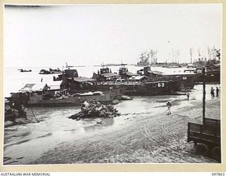 BORAM BEACH, NEW GUINEA. 1945-10-13. THE FIRST BATCH OF TROOPS TO LEAVE THE WEWAK AREA UNDER THE PRIORITY DEMOBILISATION SCHEME WERE MEMBERS OF 6 DIVISION. SHOWN, THE BARGE POINT AT BORAM BEACHHEAD ..