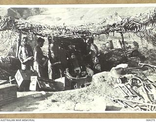 FINISTERRE RANGES, NEW GUINEA. 1944-01-23. PERSONNEL OF NO. 7 BATTERY, 2/4TH FIELD REGIMENT POUNDING JAPANESE POSITIONS WITH 25 POUNDERS IN THE LAKES AREA