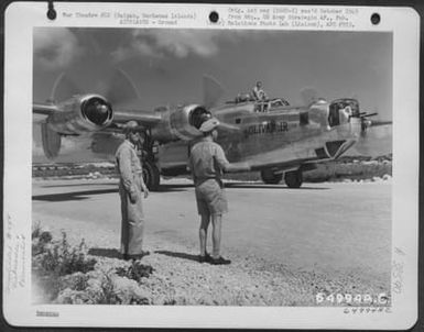 Major General Robert W. Douglass, Jr. (Right) And Colonel Lawrence J. Carr Watch The Consolidated B-24 Liberator 'Bolivar Jr.' As It Taxies To Hardstand On Saipan, Marianas Islands, 19 May 1945. (U.S. Air Force Number 64994AC)