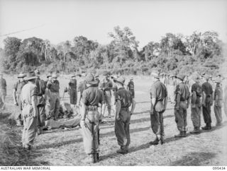 KIARIVU, NEW GUINEA, 1945-08-15. THE FUNERAL SERVICE OF PRIVATE F.W. GAGE, A COMPANY, 2/7 INFANTRY BATTALION, THE LAST BATTLE CASUALTY OF THE UNIT. THE COMMANDING OFFICER, STAFF OFFICERS AND UNIT ..