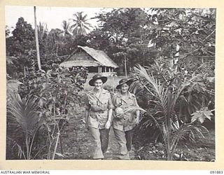 LAE, NEW GUINEA, 1945-05-16. PRIVATE A.R. BELL (1), AND PRIVATE M.G. BELL (2), THE ONLY TWO AUSTRALIAN WOMEN'S ARMY SERVICE IN SUPPLY AND TRANSPORT, HEADQUARTERS LAE BASE SUB-AREA, LEAVING THEIR ..