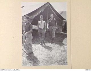 CAPE WOM, NEW GUINEA. 1945-10-19. LIEUTENANT TAZAKI, OF THE JAPANESE ARMY, BEING ESCORTED FROM THE TRIBUNAL AT HEADQUARTERS 6 DIVISION, AFTER HIS EVIDENCE HAD BEEN TAKEN BY THE WEWAK WAR CRIMES ..