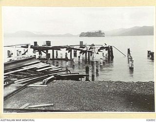 THE JETTY AT SAMARAI ISLAND DESTROYED BY AUSTRALIAN FORCES BEFORE EVACUATING THE ISLAND. THE ISLAND IS SMALL AND OF LITTLE MILITARY VALUE BUT ALL INSTALLATIONS, STORAGE TANKS AND SOME BUILDINGS ..