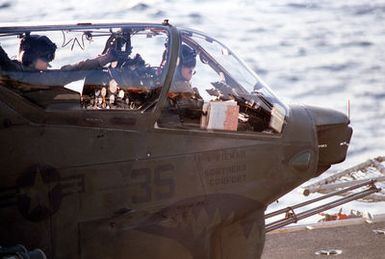 Right side view of a Marine AH-1 Sea Cobra helicopter (front section), on the flight deck of the amphibious assault ship USS GUAM (LPH 9) during operations off the coast of Beirut, Lebanon