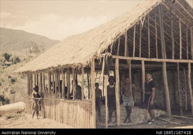 People standing inside a newly built structure