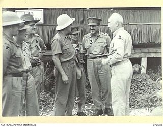 FINSCHHAFEN AREA, NEW GUINEA. 1944-04-25. THE HONOURABLE E.J. WARD, MINISTER FOR EXTERNAL TERRITORIES IN THE AUSTRALIAN GOVERNMENT (1), CHATTING WITH GENERAL BAKER, UNITED STATES ARMY (2), AND ..