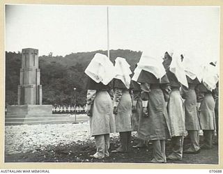 FINSCHHAFEN, NEW GUINEA, 1944-02-29. SISTERS OF THE AUSTRALIAN ARMY NURSING SERVICE, REPRESENTING NURSING UNITS IN THE AREA ARE PICTURED FACING THE MEMORIAL DURING THE OFFICIAL OPENING OF THE ..
