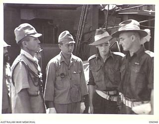 BOUGAINVILLE, 1945-09-17. THE JAPANESE COMMANDER (1), JAPANESE INTERPRETER (2), LIEUTENANT H.J. JENKINS, AUSTRALIAN INTERPRETER (3) AND CAPTAIN W. DAVIES (4), ON BOARD THE SHIP WHICH CARRIED THE ..