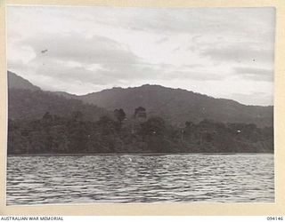 TINIAN, BOUGAINVILLE, 1945-07-18. THE SHORE VIEWED OFF THE POINT OF RESCUE OF TEN NETHERLANDS EAST INDIES ARMY PERSONNEL WHO HAD BEEN PRISONERS OF THE JAPANESE SINCE 1942-03-08. SEVERAL JAPANESE ..