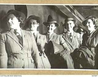 TOWNSVILLE, NORTH QUEENSLAND, AUSTRALIA. 1944-06-27. NURSING SISTERS OF THE 2/5TH GENERAL HOSPITAL WAITING TO DISEMBARK FROM THE H.M.T. "ORMISTON" ON THEIR ARRIVAL FROM NEW GUINEA. THEY ARE:- ..