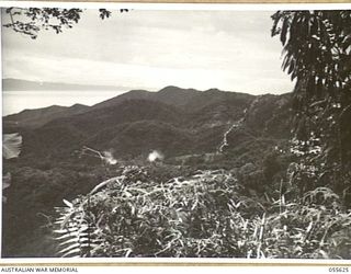 SALAMAUA, NEW GUINEA, 1943-08-09. ARTILLERY SMOKE SHELLS FIRED DURING RANGING ON ORODUBI. PHOTOGRAPH TAKEN FROM WELLS OBSERVATION POST