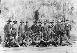 Group portrait of Naval Officers of the Australian Naval and Military Expeditionary Force to German New Guinea. Identified in the back row (standing) from left to right: Sub Lieutenant (Sub Lt) ..