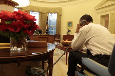Barack Obama makes a phone call in the Oval Office