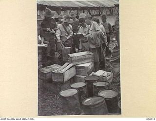 MUSCHU ISLAND, NEW GUINEA. 1945-09-11. JAPANESE ADMINISTRATIVE OFFICERS CHECKING STORES SUPPLIED BY HEADQUARTERS 6 DIVISION. THE RATIONS CONSISTED OF RICE, TEA, SUGAR AND BULLY BEEF. MUSCHU AND ..