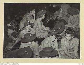 LAE, NEW GUINEA, 1945-05-07. AWAS PERSONNEL SITTING ON THEIR GEAR WAITING TO DISEMBARK FROM THE MV DUNTROON. THEY ARE PART OF A GROUP OF 342 AWAS FROM AUSTRALIA EN ROUTE TO AWAS BARRACKS AT BUTIBUM ..