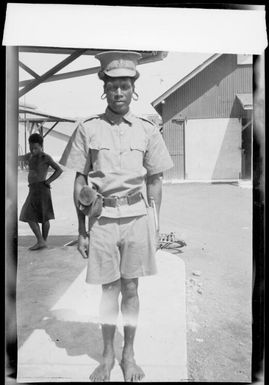 Uniformed policeman with a bugle, Rabaul Harbour, New Guinea, 1937 / Sarah Chinnery