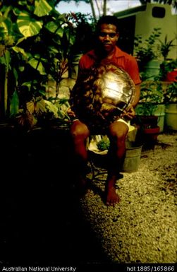 Man holding large turtle shell