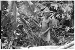 Fa'ani, 'Elota's daughter, with axe in garden